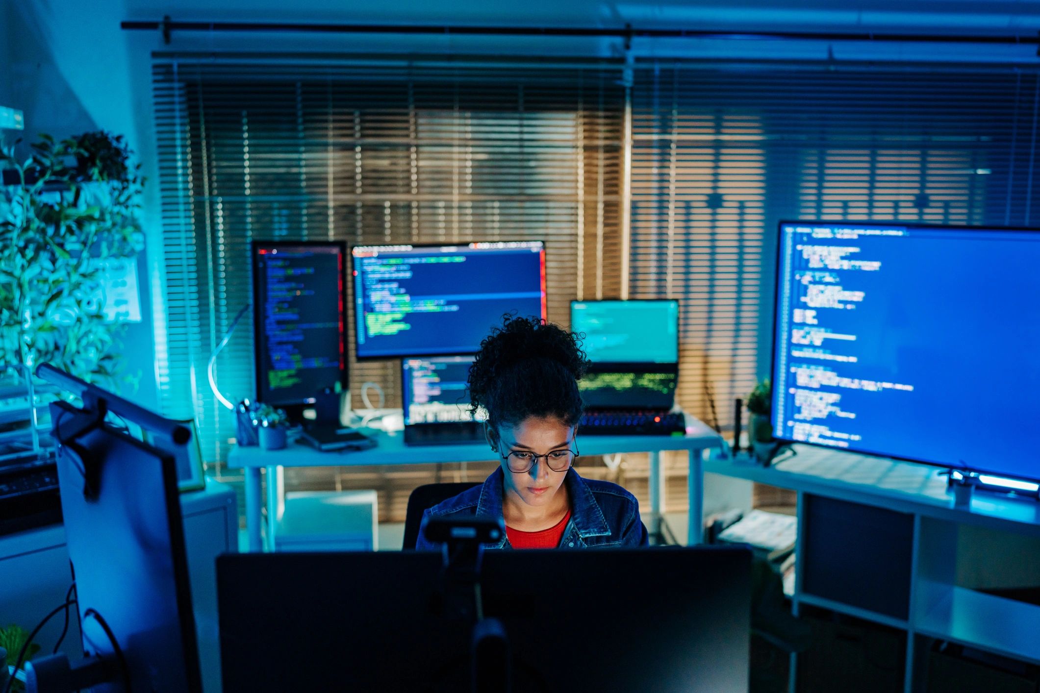 Developer working at a multi-monitor workstation